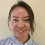 A dark-haired woman smiling